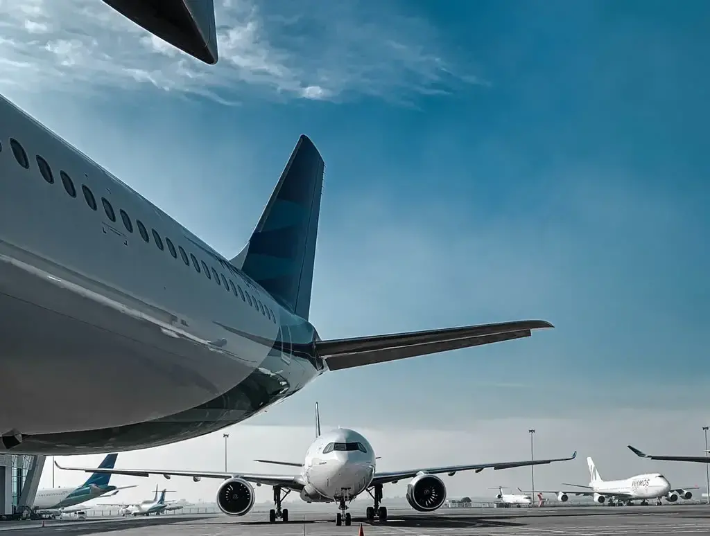 View of two aircraft on the runway at Dallas Fort Worth Airport, preparing for takeoff