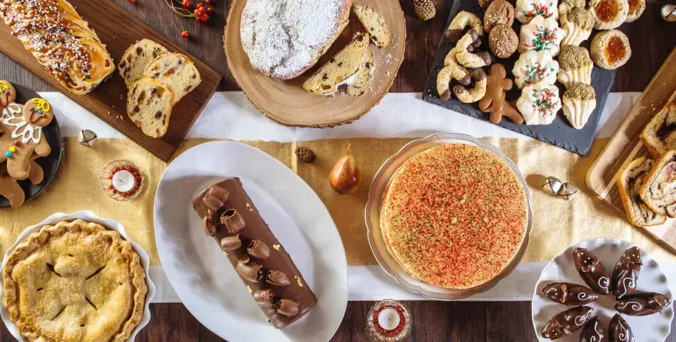 A table with several pastries and cookies served in plates and tables